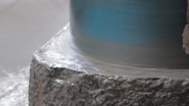 High-speed grinder operating on basalt surface