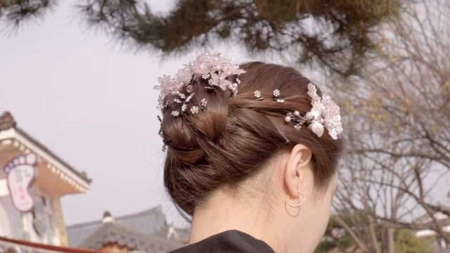 A woman wearing traditional Korean hanbok and a headdress