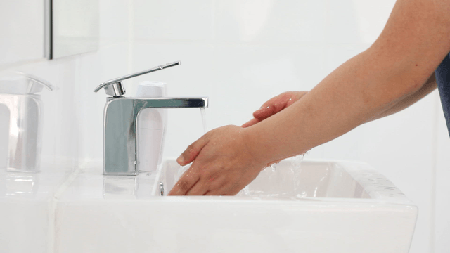 Hands being washed under running water