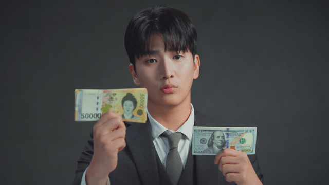 Man comparing Korean won and US dollars