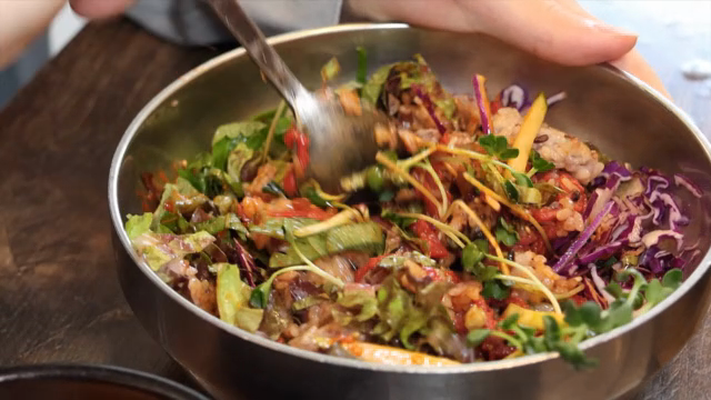 Preparing a bowl of Korean yukhoe bibimbap