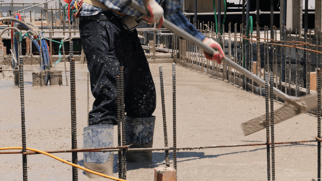 Construction worker smoothing concrete