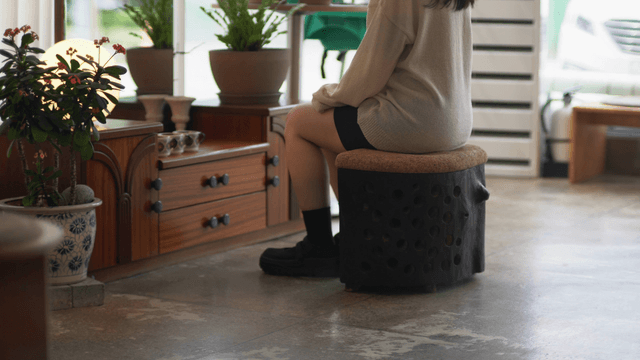 Woman sitting on a wooden chair in a cozy interior