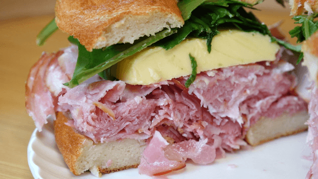 A fresh sandwich with ham and greens