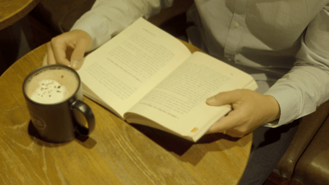 Reading a book with a cup of coffee