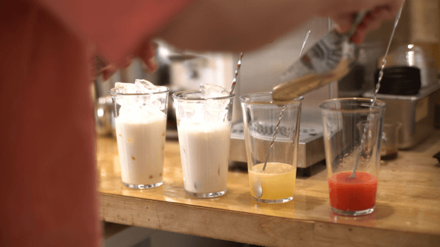 Various drinks being prepared on a counter