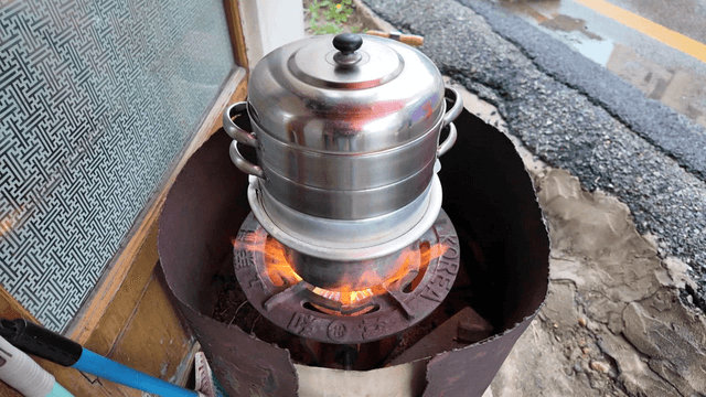 Steamer boiling on a strong flame outdoors