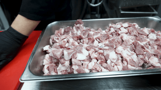 Chopped pork on red cutting board