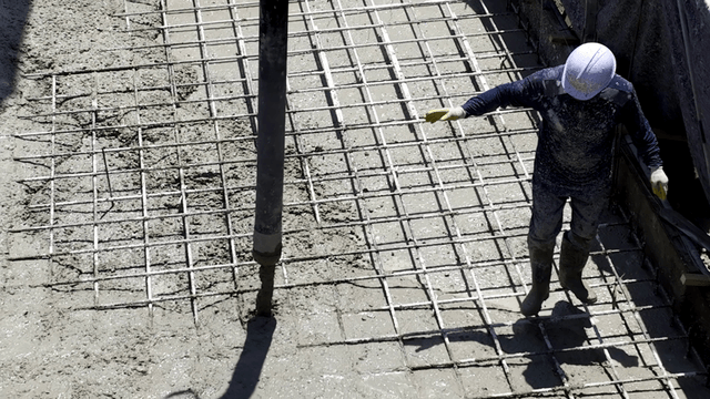 Construction workers pouring concrete