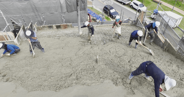 Workers pouring concrete on a building site