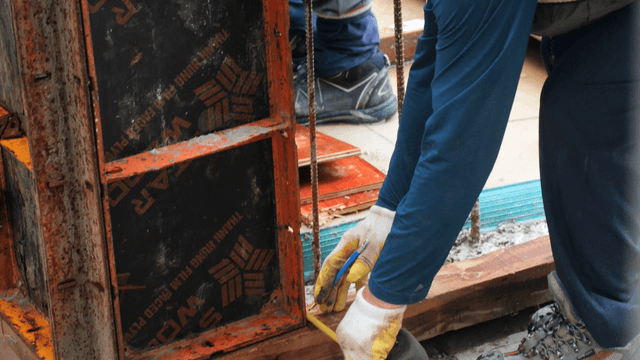 Worker measuring at a construction site