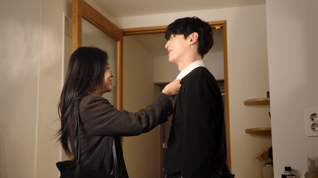 Couple smiling and adjusting clothes