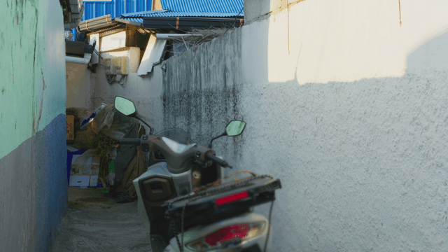 Narrow alley with a parked scooter