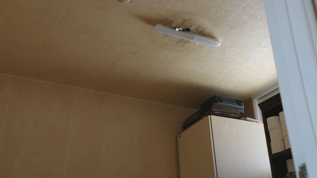 Small indoor room with a ceiling light