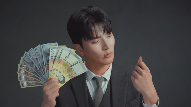 Man smiling at the Bitcoin in his hand