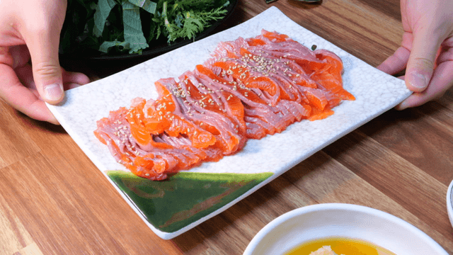 Fresh trout sashimi plate with sesame garnish