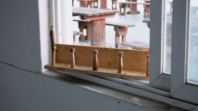 Wooden stand placed by the window in a quiet room