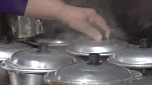 Steaming pots on a stove in a kitchen