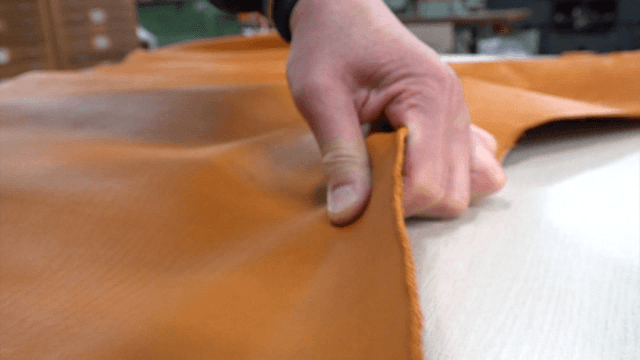 Inspecting leather elasticity by hand