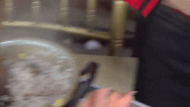 Grandmother serving rice with beans and chestnuts