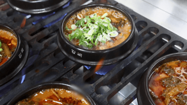 Earthen pot kimchi stew cooking on stove