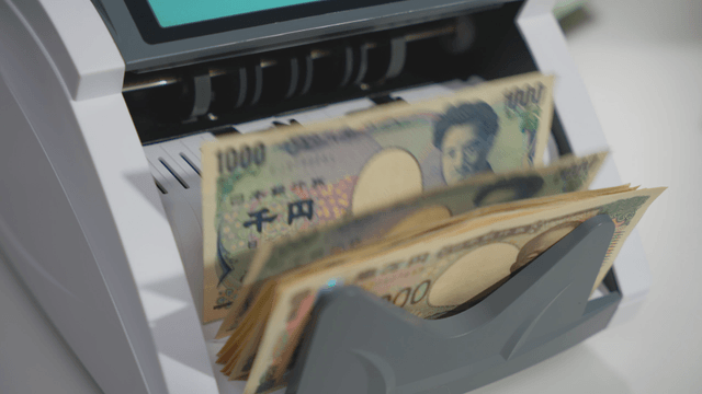 A money counting machine processing bills