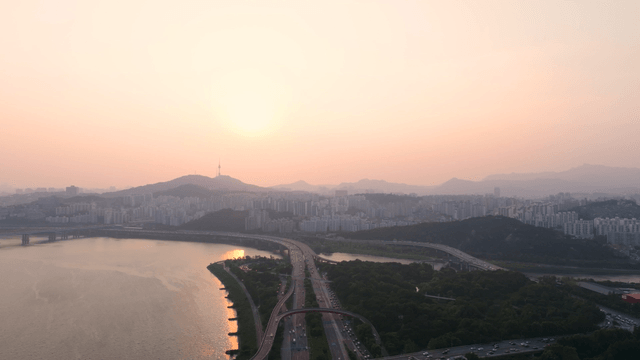 Busy Seoul road with bridge over the Han River