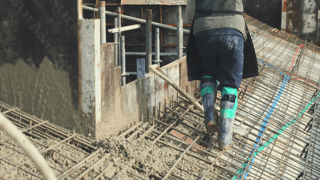 Worker pouring concrete on a construction site