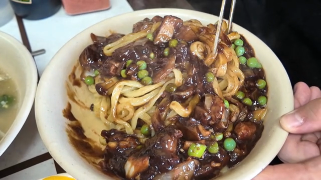 Jajangmyeon being mixed in a bowl
