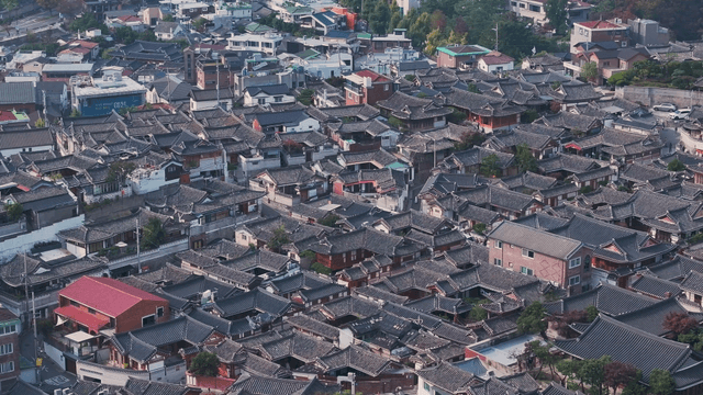Panoramic view of a Hanok village lined with traditional tiled roofs