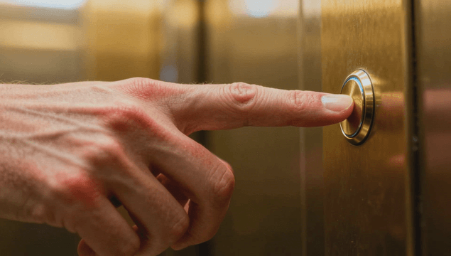 A finger pressing an elevator button