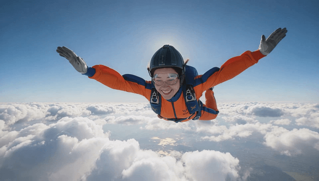Female skydiver descending above the clouds