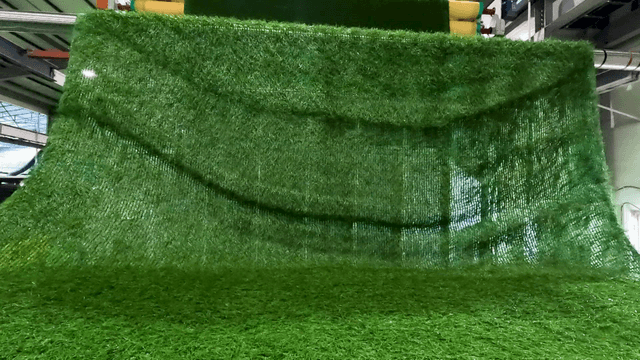 Factory machine rolling up artificial turf