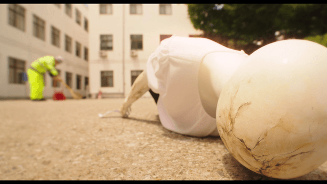 Mannequin lying in parking lot