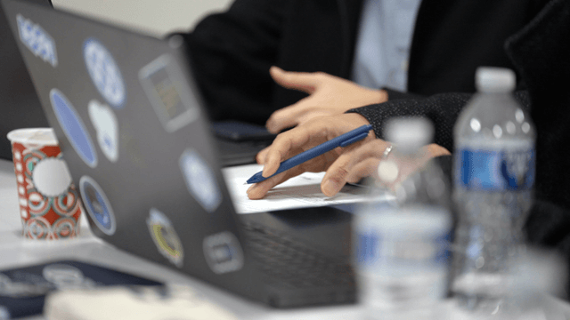 Person taking notes during a meeting