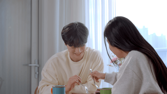 Couple feeding each other cake with forks