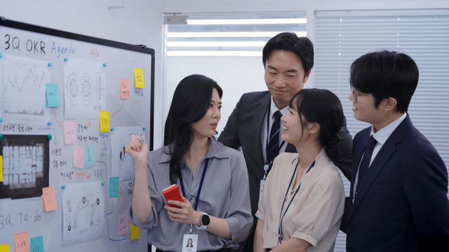 Team discussing strategy at a whiteboard