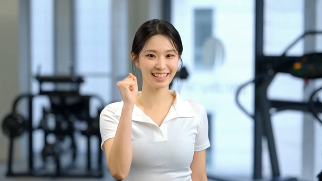 Young woman cheering with clenched fists at gym