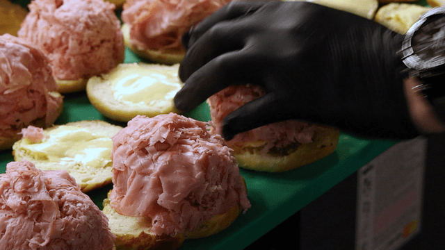 Preparing sandwiches with ham and pesto