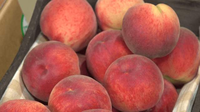 Fresh peaches packed in a wooden box