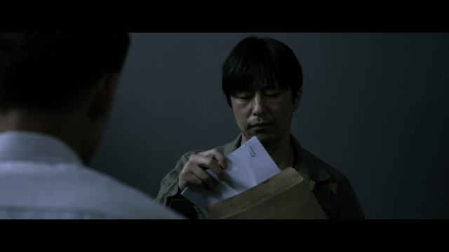 Two men talking while showing documents