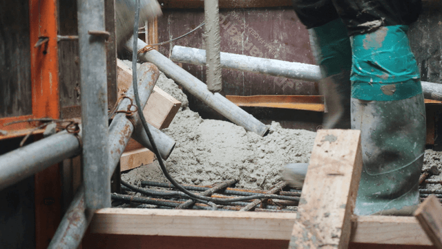 Workers pouring concrete at a construction site