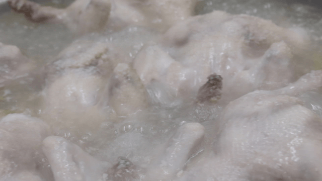 Boiling whole chickens in a pot