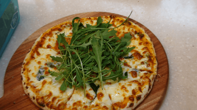 Margherita pizza topped with plenty of arugula