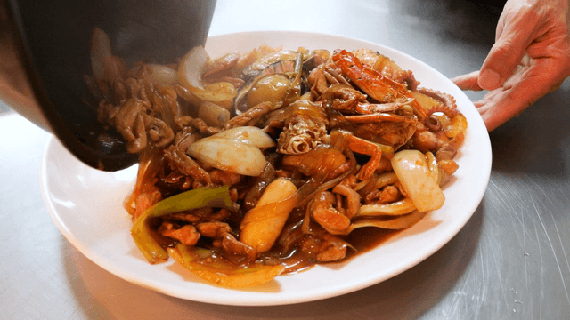 Seafood braised chicken poured onto a plate
