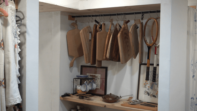 Kitchen corner with cutting boards and tennis racket
