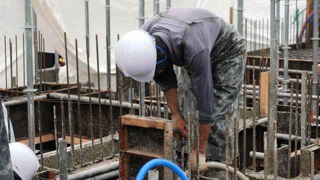 Construction workers pouring concrete