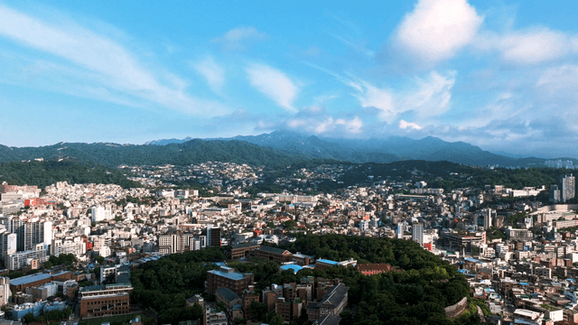 Sprawling city with mountains in the background