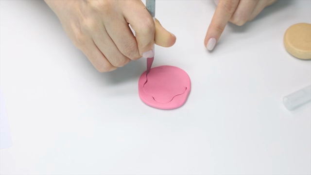 Hands crafting with pink clay