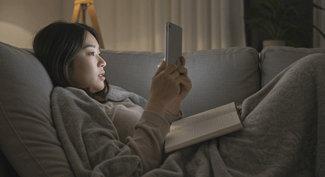 Woman relaxing on a sofa using a tablet